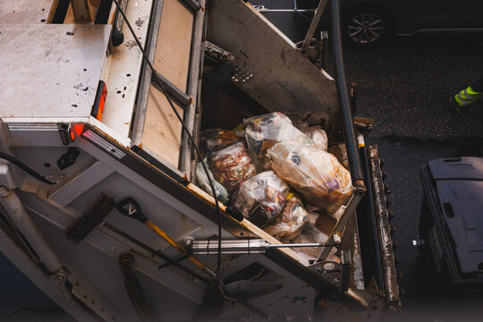 Gritty overhead view in Alesund, Norway, captures colorful plastic trash bags