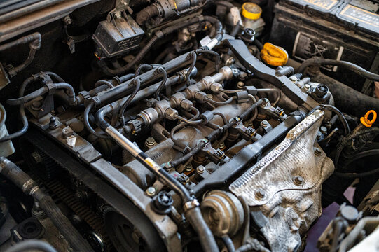 Detailed view of a modern diesel engine with common rail fuel injection system inside the engine bay during maintenance and inspection in an automotive workshop