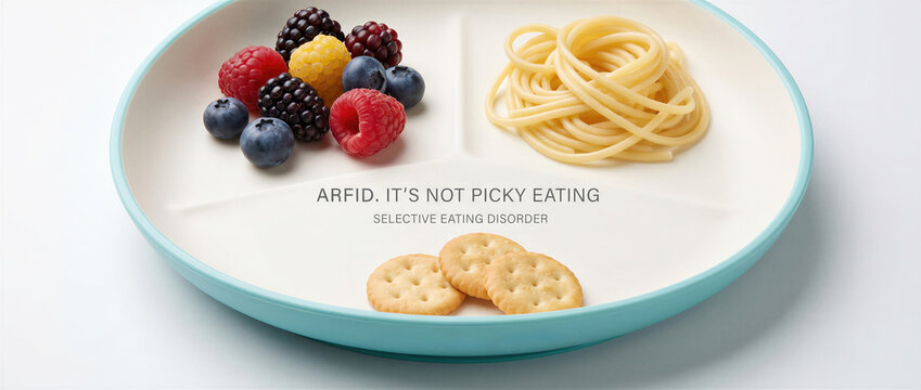 Divided plate with selective food portions and text about arfid. Conceptual representation of avoidant restrictive food intake disorder. Banner with copy space