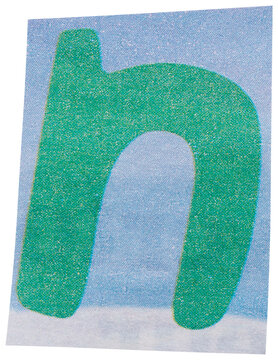 Green letter N on white blue backdrop cut out from vintage newspaper, isolated single ransom letter