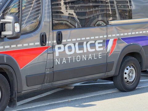 French national police vehicles at Calais beach conducting high-visibility patrols for public safety. 