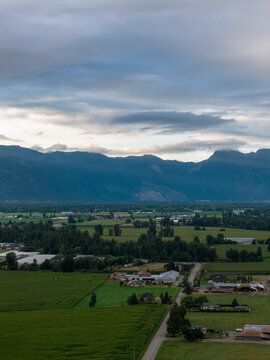 Aerial View of Farmland and Mountains Near Chilliwack, British Columbia, Canada With Overcast Sky