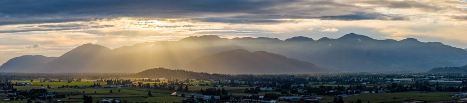 Golden Sunrise Over Chilliwack Valley Farmland With Misty Mountains in British Columbia, Canada