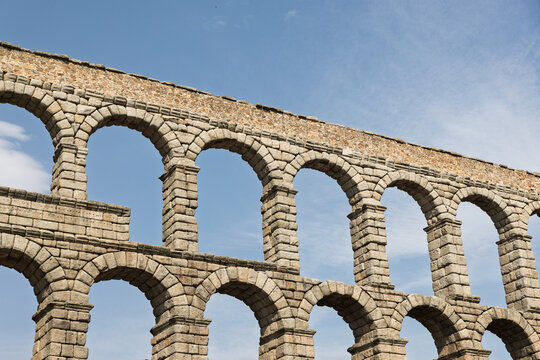 Segovia, spain; 07 25 2026 segovia aqueduct arches against blue sky