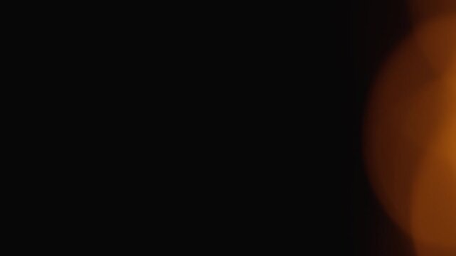 Soft orange glow with smooth gradient transitions blends into deep black, evoking a sense of warmth and intrigue. Ideal for backgrounds, presentations, and contemporary visual concepts