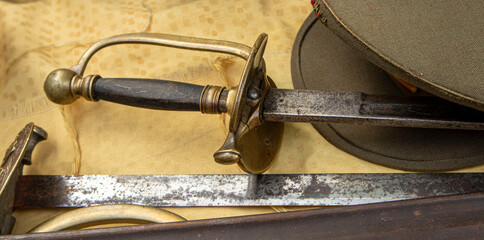 Obraz premium Antique military rapier and uniform cap showcasing history of armed forces