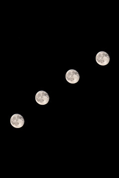 Stunning lunar trail showing the full sequence of moon phases across the night sky, from waxing crescent to full moon and waning phases.