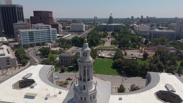flying counter clockwise around Denver City Hall revealing downtown skyline