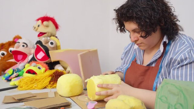 Artisan woman creating puppet heads in her workshop