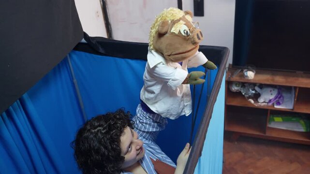 Female puppeteer operating a pig puppet show