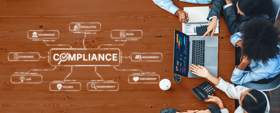 Business professionals engage in a meeting focused on compliance strategies, showcasing a laptop with data analysis and digital graphics, fostering teamwork and effective planning. Trope
