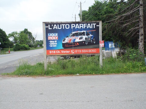 Gatineau, Quebec, Canada &ndash; June 11, 2026: A large billboard for "L'Auto Parfait" featuring Liqui Moly motor oil and a race car stands near Chemin Vanier.