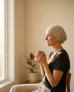 Woman resting peacefully near a sunlit window during health recovery