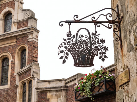 wrought iron cut out hanging sign of basket of flowers for florists shop