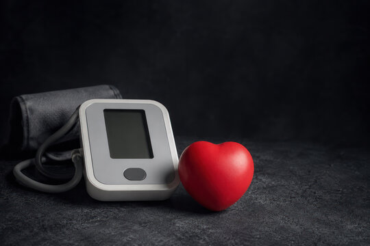Home blood pressure monitor with red heart and copy space