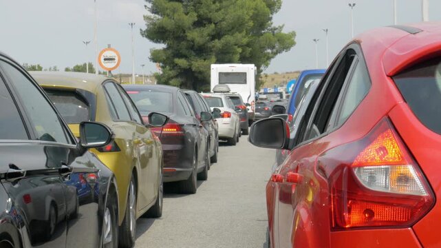 Traffic jam with long line of cars waiting at border crossing checkpoint