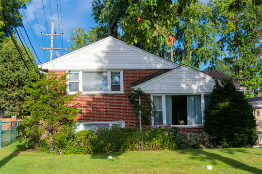 Residential neighborhood house in developed area. Property insurance and real estate. Suburban neighborhood street. Private property house. House insurance. Property in neighborhood
