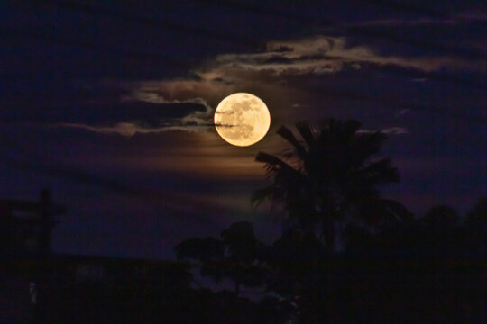 Full moon in the night sky with clouds
