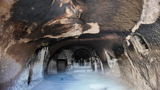 the interior of Vardzia cave monastery in Georgia, a stunning 12th-century structure carved into the Erusheti cliffs, showcasing intricate rock-cut architecture and soot traces