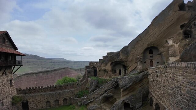 David Gareji monastery complex presents ancient cave structures and church buildings carved into desert hillsides, reflecting historical religious architecture and unique cultural landmark in Georgia