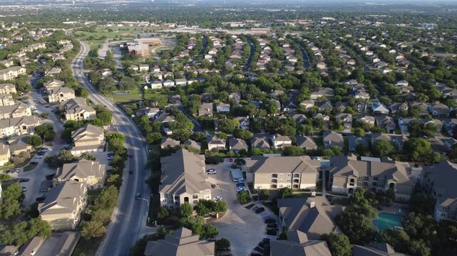 Curved thoroughfares wind past master planned community dense housing multi family apartments near Culebra Road. Winding roadways frame suburban houses swimming pool amenities, San Antonio, TX