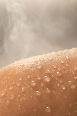 Fototapeta premium Water droplets on skin after hot spring bath steam background beauty close-up