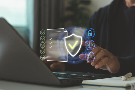 Businessman using laptop with digital compliance interface, technology, cybersecurity, data protection, document verification, legal compliance, privacy, audit, and secure business governance.