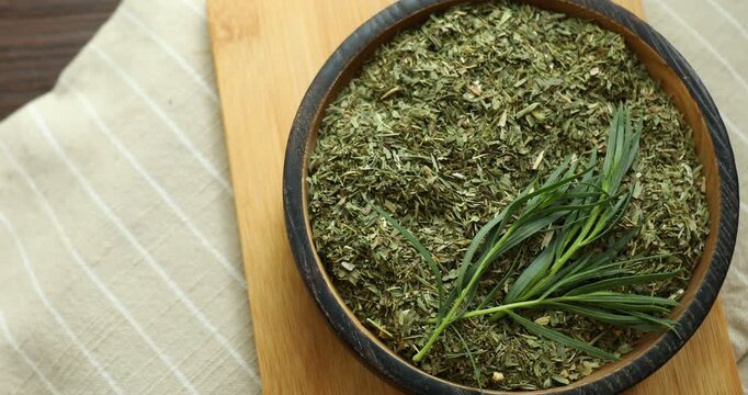 Dried and fresh tarragon in bowl on table, top view