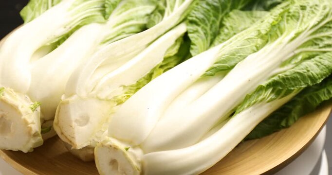 Fresh bok choy cabbages on table, rotating