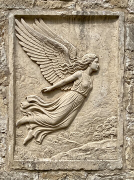 stone relief featuring a classical-style winged angel