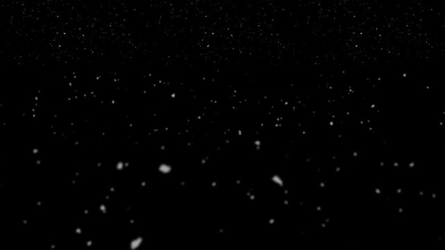 Snowflakes fall gently against a pitch-black background creating a serene winter atmosphere.