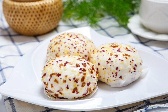 Three colorful crispy crumb coated steamed buns white plate grid tablecloth