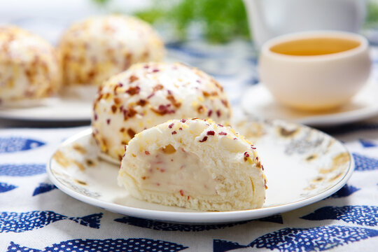 Three colorful crispy crumb coated steamed buns white plate grid tablecloth