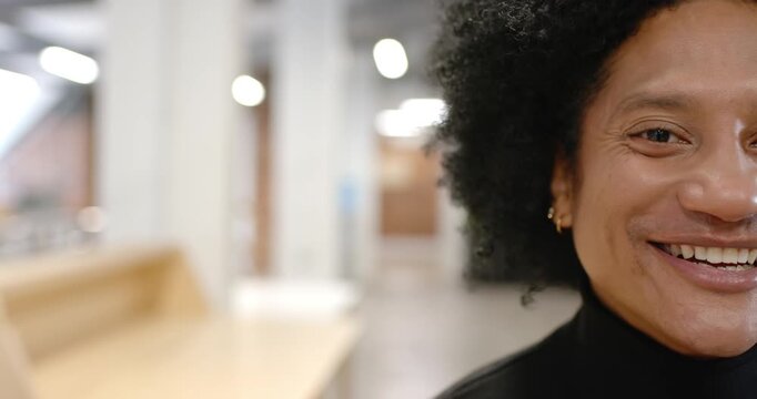 Adult African American woman entering office right side, smiling laughing at bench, copy space