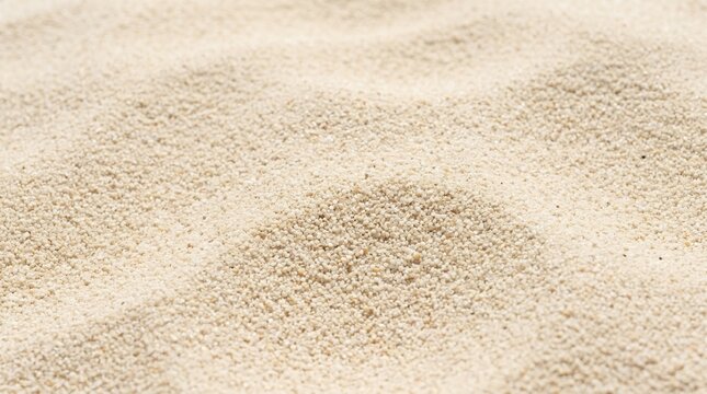 Close up of fine sand texture with gentle waves and shadows.