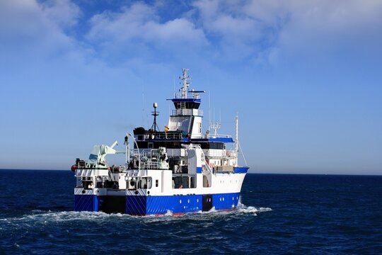 Trauler fishing boat sailing along the Mediterranean coast of Spain. 
