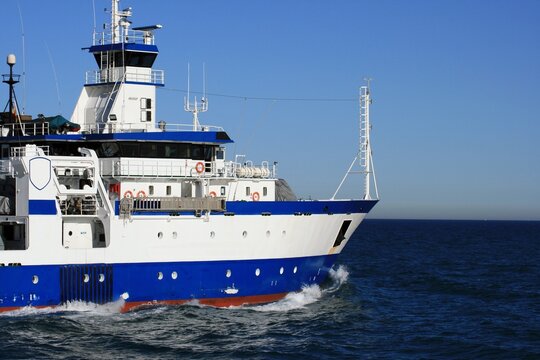 Trauler fishing boat sailing along the Mediterranean coast of Spain. 