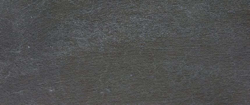 Natural black slate texture background, dark grey stone surface with organic grain, charcoal rock material for architectural design and backdrop