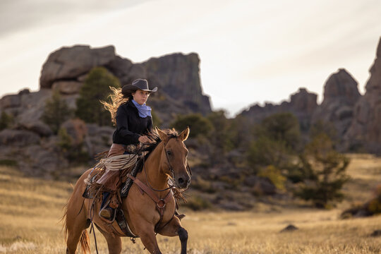 Wyoming Ranch Cowgirl with AQHA Quarter Horse running 