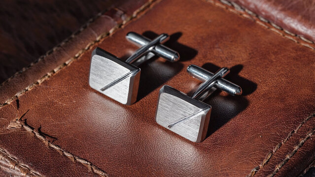 modern trendy silver crafted stud on leather background.ai 