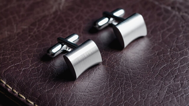 modern trendy silver crafted stud on leather background.ai 