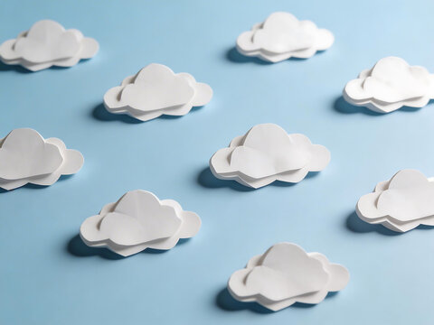 Paper cloud cutouts on blue surface