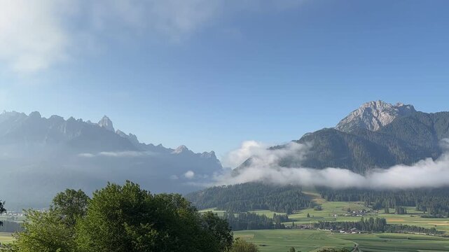 Time-lapse of dramatic clouds drifting over the breathtaking alpine landscape of the Puster Valley (Val Pusteria), South Tyrol, Italy, showcasing the ever-changing beauty of the Dolomites beneath a vi