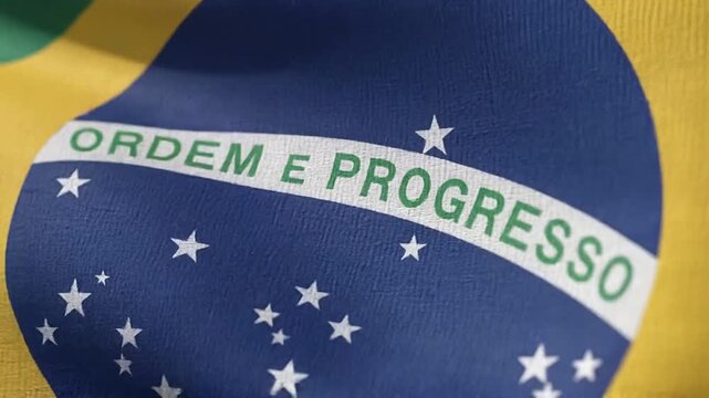 Close up of the flag of Brazil, showing the national motto Ordem e Progresso and stars