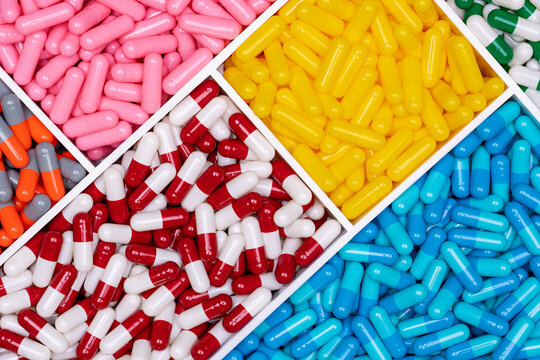 Top view of colorful capsule pills in plastic tray. Pharmaceutical industry. Healthcare and medicine. Drug production. Pharmaceutics concept. Vitamins and supplements capsules. Bright color capsule.