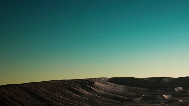 Landscape shows large hills with smooth contours. The sky is clear and bright. This scene captures the natural beauty of the land. The time is during the day, with sunlight present.