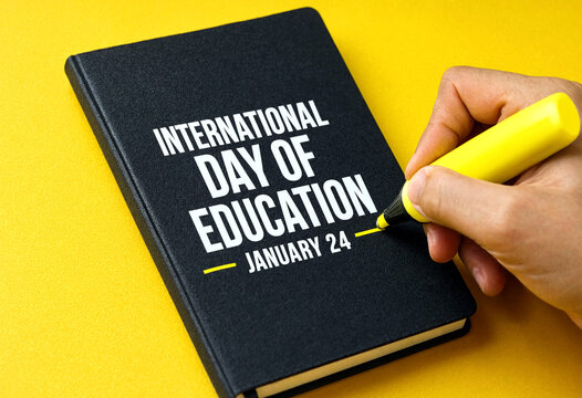 Hand highlighting international day of education date in notebook for awareness campaign