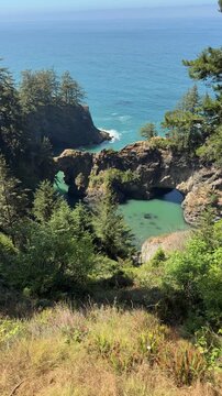 Natural Bridges in Brookings, Oregon, as seen from scenic viewpoint, on a summer day.