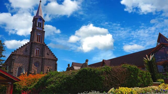 Historic Church of St Nicholas and Medieval Church of St John the Baptist in Tallinn Estonia with Brick Architecture Tower Roof and Blue Sky