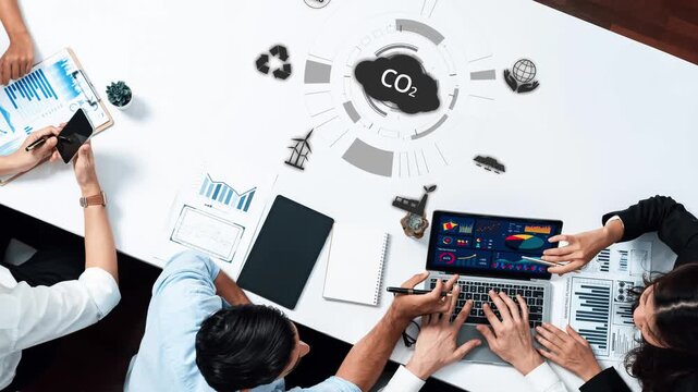 A group of business professionals engages in a collaborative effort to analyze CO2 emissions, leveraging technology and data visualization for informed decision-making. Raster